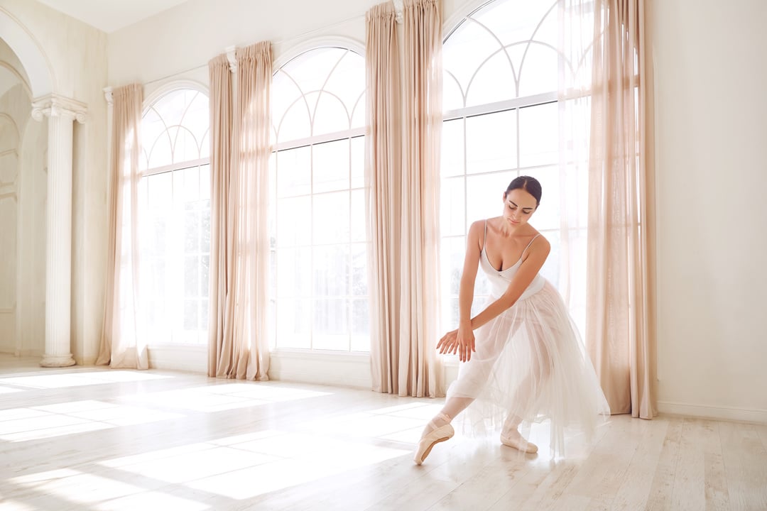 Ballerina Dancing in a Studio on Background Window.